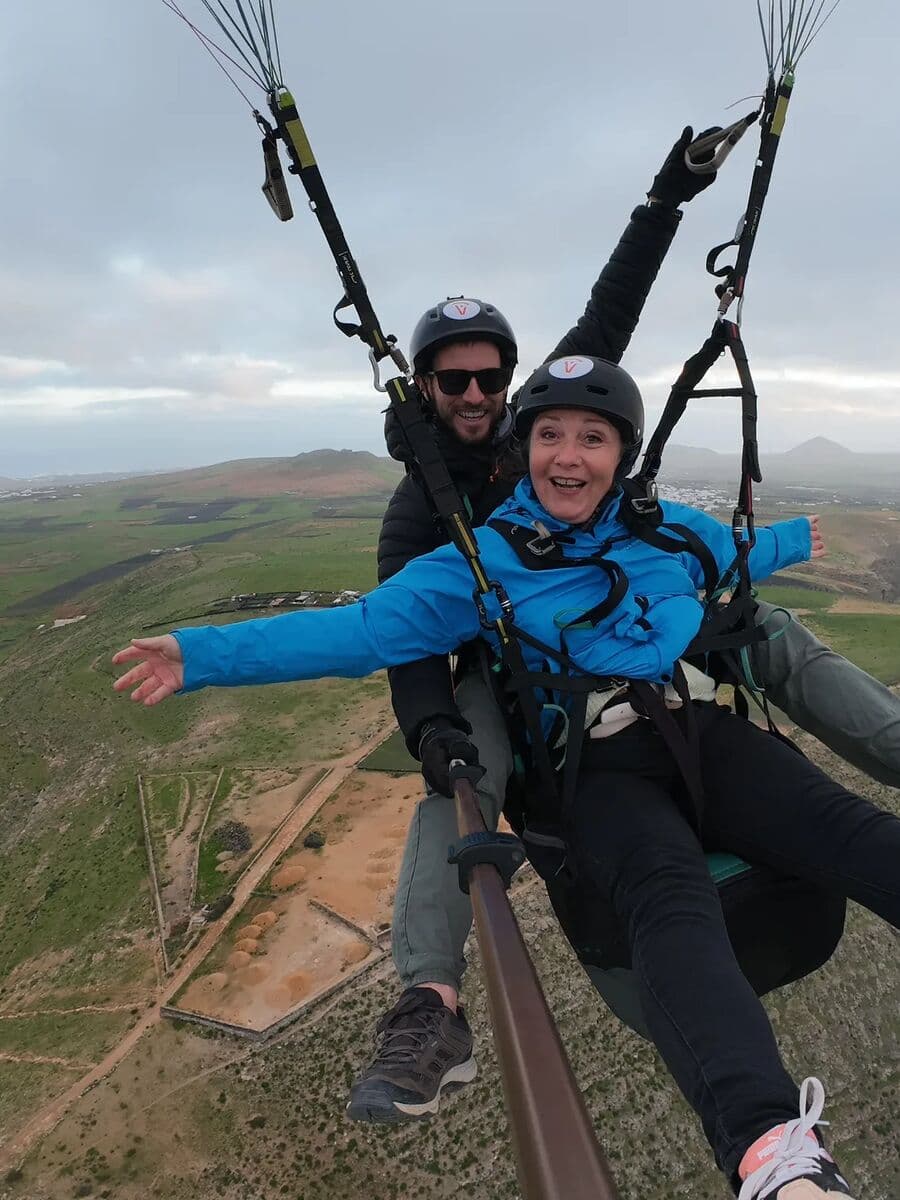 A tandem passenger with arms spread over the Lanzarote countryside