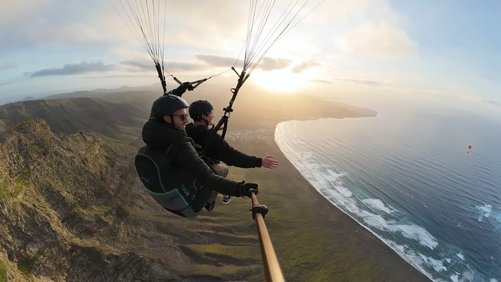 A tandem flight over Famara beach at sunset